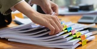 person going through a sack of papers