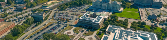 Arial photo of the state offices campus Showing three large office buildings with solar panels around aa courtyard 