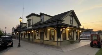 Exterior of Kingston Train Station lit up by LEDs at sunset.
