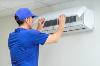 A mini split heat pump system being installed
