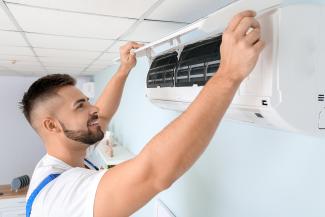 A technician installing a mini split system