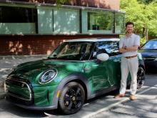 Errol standing next to his electric mini cooper 